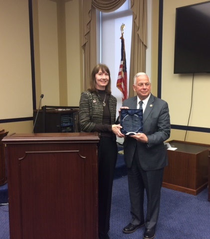 Nuala Moore, ATS Washington office staff presents TB Caucus Co-chair Rep. Gene Green (D-TX) with TB Champion Award
